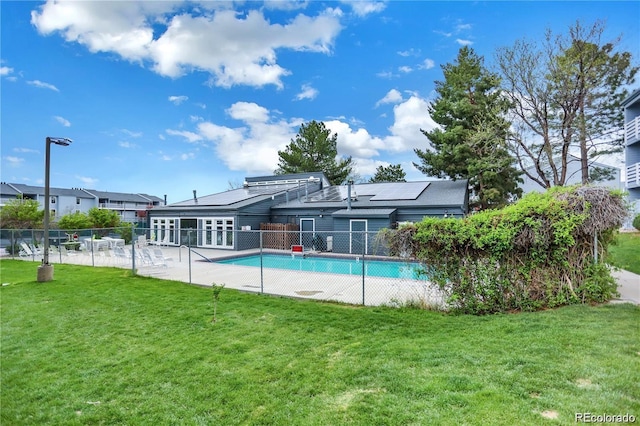 view of swimming pool featuring a yard, a fenced in pool, and fence