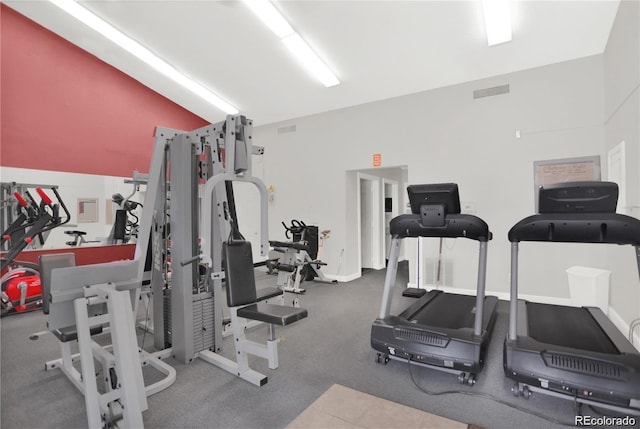 gym featuring vaulted ceiling and visible vents