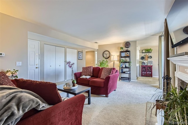 living room with light carpet, a fireplace, and baseboards