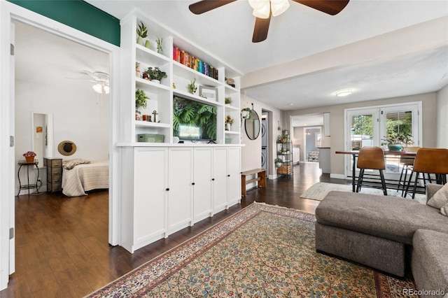 living room with ceiling fan and dark wood-style flooring