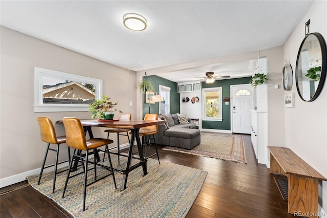 dining room featuring a ceiling fan, baseboards, and wood-type flooring