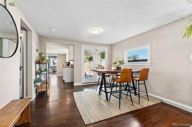 dining room featuring dark wood-type flooring and baseboards