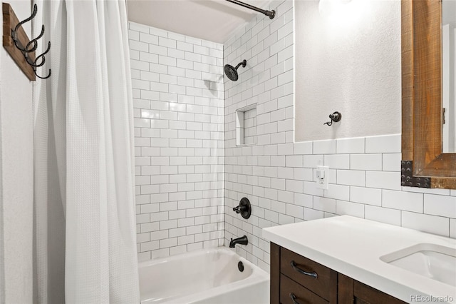 bathroom featuring backsplash, shower / tub combo with curtain, tile walls, and vanity