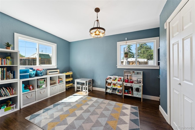 rec room featuring baseboards and wood finished floors