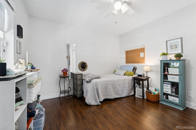 bedroom with ceiling fan, baseboards, and wood finished floors