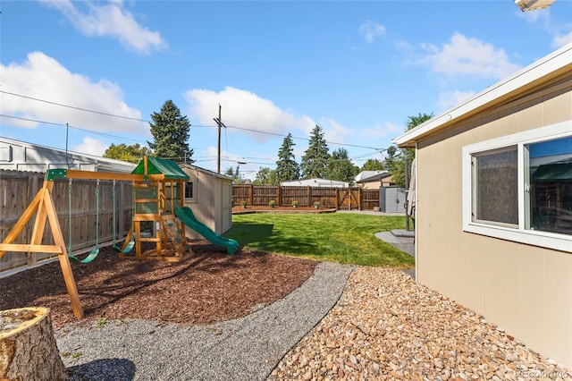 view of yard with a playground and a fenced backyard