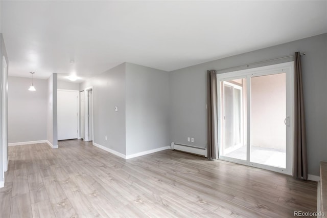 8330 Zuni St Unit 116, Denver, CO 80221 - unfurnished room with light wood finished floors and a baseboard radiator