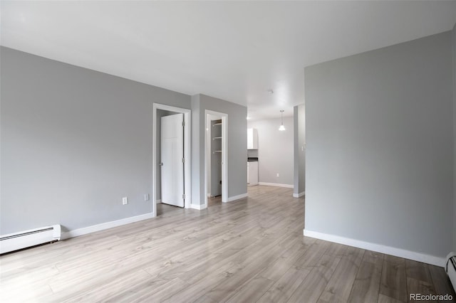 8330 Zuni St Unit 116, Denver, CO 80221 - unfurnished room with baseboard heating and light wood finished floors