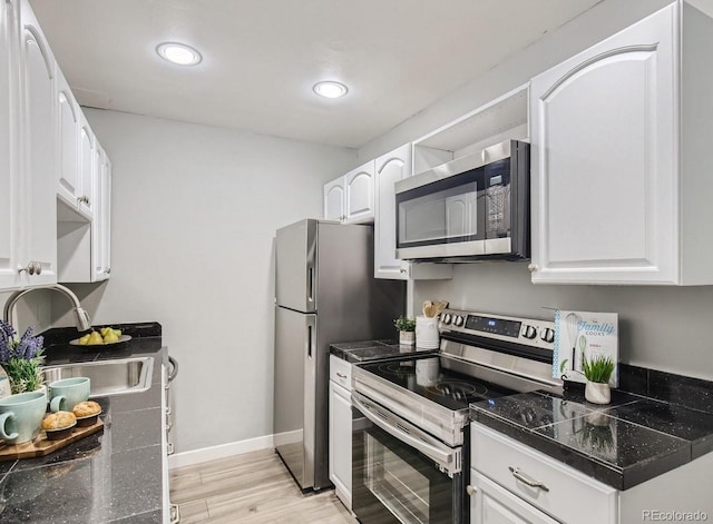 8330 Zuni St Unit 116, Denver, CO 80221 - kitchen with stainless steel appliances, light wood-style flooring, white cabinets, and recessed lighting