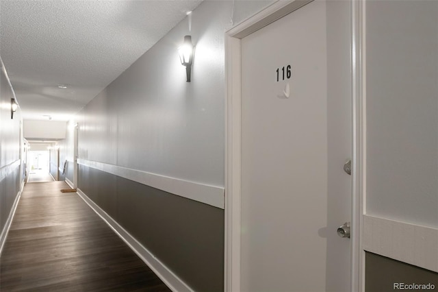8330 Zuni St Unit 116, Denver, CO 80221 - hallway featuring dark wood-style floors and a textured ceiling