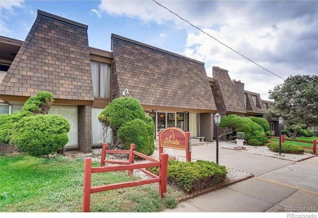 8330 Zuni St Unit 116, Denver, CO 80221 - view of front of house with mansard roof and brick siding