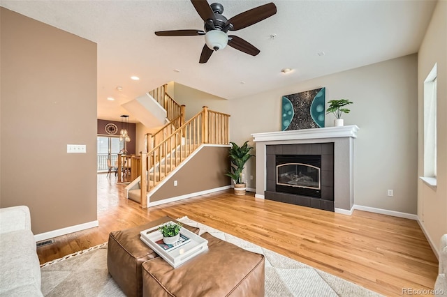 453 S Quay St, Lakewood, CO 80226 - unfurnished living room featuring stairway, baseboards, a fireplace, and wood finished floors