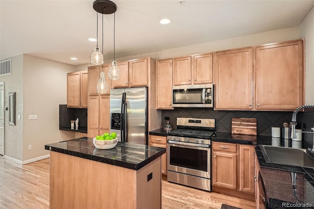 453 S Quay St, Lakewood, CO 80226 - kitchen featuring light brown cabinetry, tile counters, stainless steel appliances, decorative backsplash, and visible vents