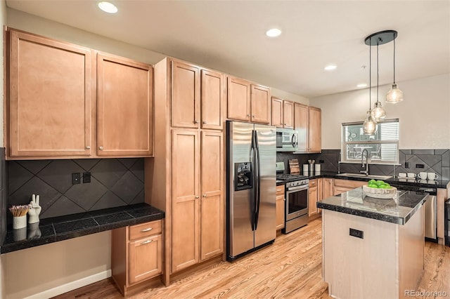 453 S Quay St, Lakewood, CO 80226 - kitchen with light brown cabinetry, appliances with stainless steel finishes, a sink, light wood-style floors, and tile counters