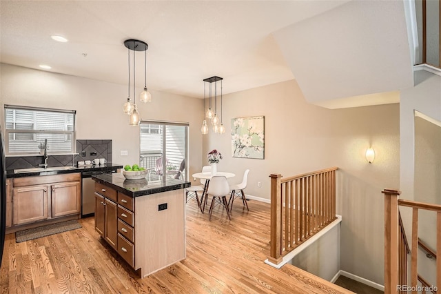 453 S Quay St, Lakewood, CO 80226 - kitchen featuring dishwasher, light wood-style flooring, a center island, backsplash, and pendant lighting