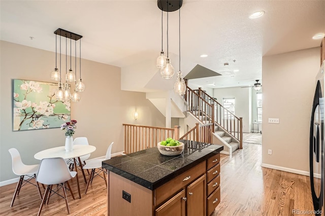 453 S Quay St, Lakewood, CO 80226 - kitchen featuring baseboards, tile counters, light wood-type flooring, and ceiling fan
