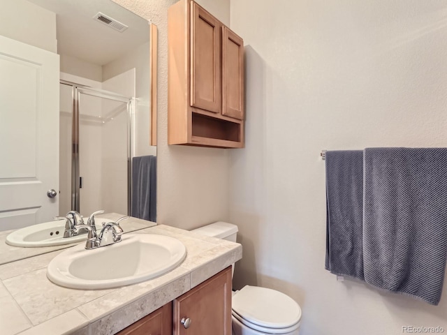 453 S Quay St, Lakewood, CO 80226 - full bathroom with visible vents, vanity, toilet, and a shower stall