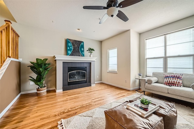 453 S Quay St, Lakewood, CO 80226 - living area featuring baseboards, ceiling fan, wood finished floors, and a fireplace