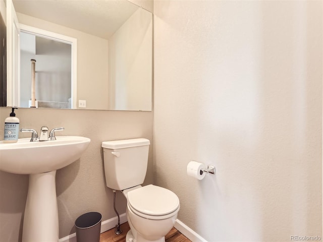 453 S Quay St, Lakewood, CO 80226 - half bath with toilet, baseboards, a sink, and wood finished floors