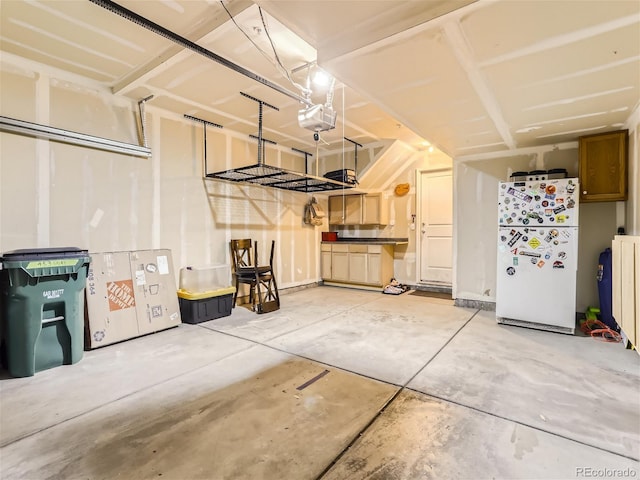 453 S Quay St, Lakewood, CO 80226 - garage with freestanding refrigerator and a garage door opener