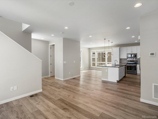 3654 Penang Dr, Castle Rock, CO 80109 - unfurnished living room with recessed lighting, light wood-type flooring, and stairway