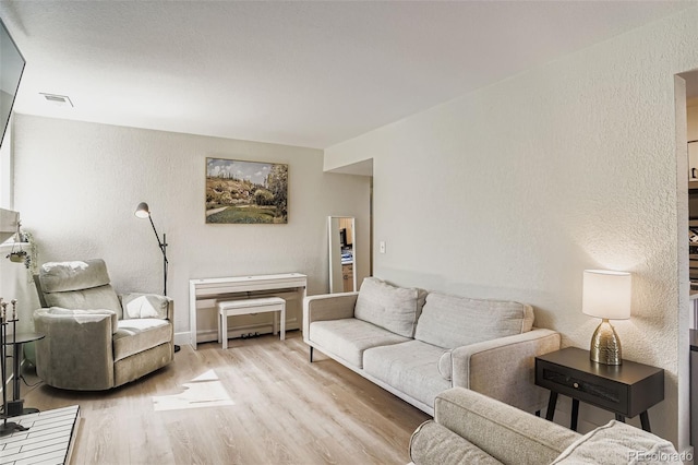 17630 E Loyola Dr Unit 1812L, Aurora, CO 80013 - living room featuring wood finished floors and a textured wall