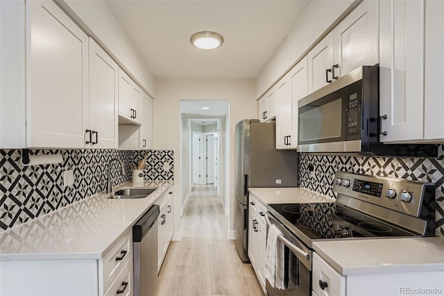 17630 E Loyola Dr Unit 1812L, Aurora, CO 80013 - kitchen featuring stainless steel appliances, light countertops, white cabinetry, light wood-type flooring, and tasteful backsplash