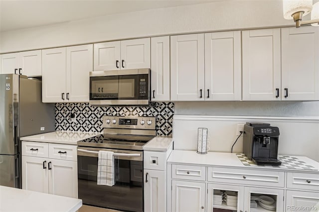 17630 E Loyola Dr Unit 1812L, Aurora, CO 80013 - kitchen with stainless steel appliances, light countertops, white cabinetry, and backsplash