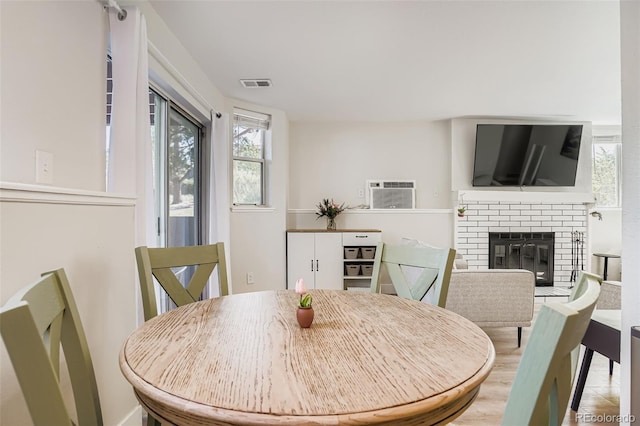 17630 E Loyola Dr Unit 1812L, Aurora, CO 80013 - dining room with a wall mounted AC and a brick fireplace