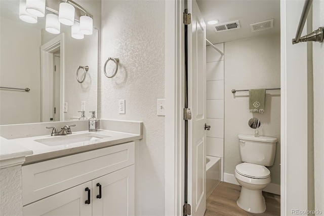 17630 E Loyola Dr Unit 1812L, Aurora, CO 80013 - full bathroom featuring vanity, wood finished floors, bathtub / shower combination, and a textured wall