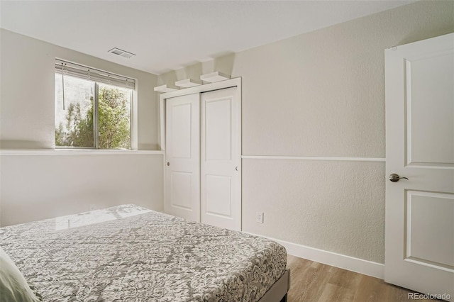 17630 E Loyola Dr Unit 1812L, Aurora, CO 80013 - bedroom featuring wood finished floors and a closet