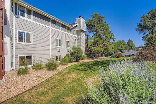 17630 E Loyola Dr Unit 1812L, Aurora, CO 80013 - view of property exterior with a chimney and a lawn