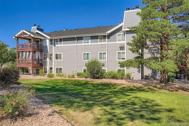 17630 E Loyola Dr Unit 1812L, Aurora, CO 80013 - back of house featuring a balcony, a chimney, and a lawn