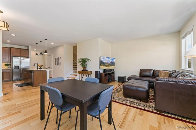 671 Robert St, Longmont, CO 80503 - dining space with stairs, light wood-style floors, and recessed lighting