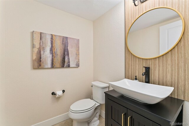 671 Robert St, Longmont, CO 80503 - bathroom with baseboards, vanity, and toilet