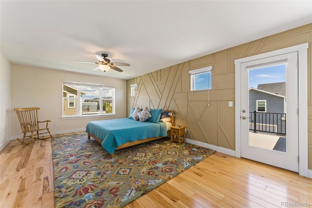 671 Robert St, Longmont, CO 80503 - bedroom with light wood-style flooring, access to exterior, a ceiling fan, and baseboards