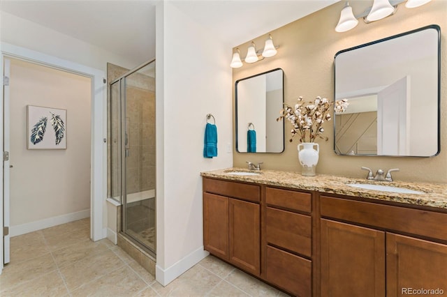 671 Robert St, Longmont, CO 80503 - full bathroom with double vanity, a stall shower, tile patterned floors, and baseboards