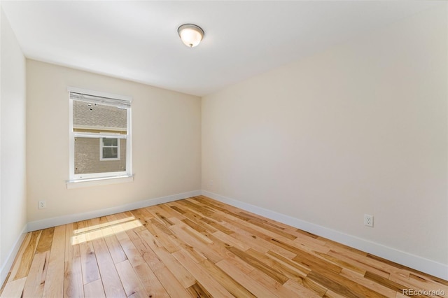 671 Robert St, Longmont, CO 80503 - empty room featuring hardwood / wood-style floors and baseboards