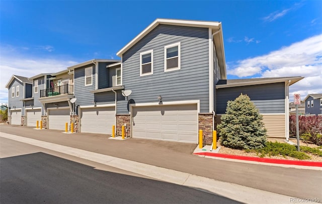 671 Robert St, Longmont, CO 80503 - view of front of home with stone siding and an attached garage