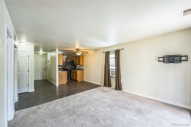 225 E 8th Ave Unit 10, Longmont, CO 80504 - unfurnished living room with dark carpet, ceiling fan, and cooling unit