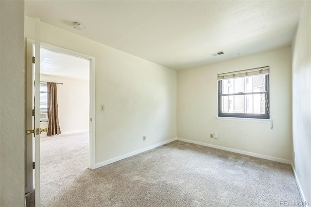 225 E 8th Ave Unit 10, Longmont, CO 80504 - carpeted spare room featuring a smoke detector and healthy amount of natural light