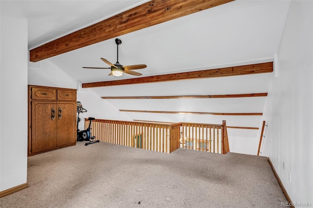 additional living space with ceiling fan, lofted ceiling with beams, and light carpet