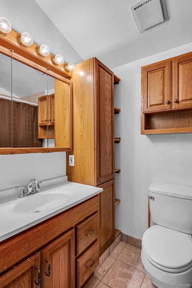 bathroom featuring a shower with curtain, tile patterned flooring, vanity, and toilet