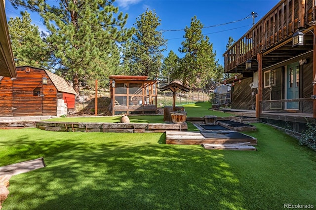 view of yard with a wooden deck and an outbuilding