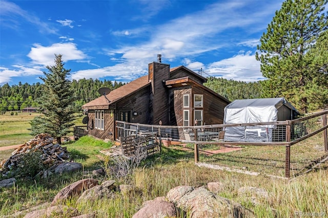 view of side of property with an outdoor structure