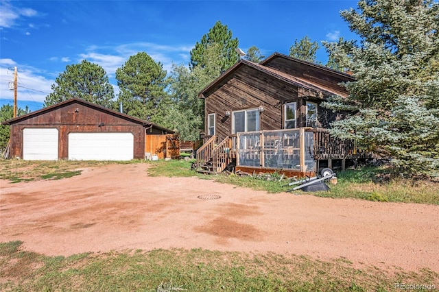 view of side of property with a garage and an outdoor structure