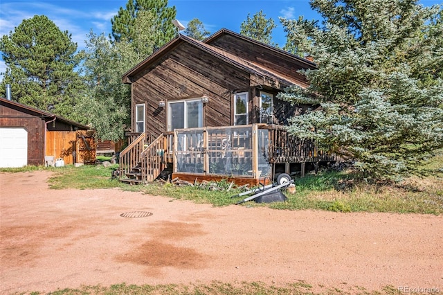 view of front of house featuring a garage and a wooden deck