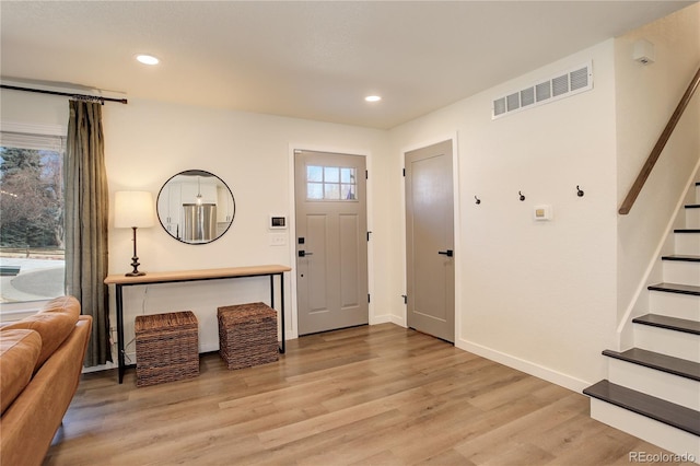 entrance foyer with recessed lighting, visible vents, baseboards, stairs, and light wood-type flooring