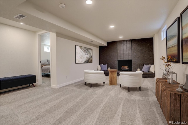 living area featuring recessed lighting, light carpet, a fireplace, visible vents, and baseboards