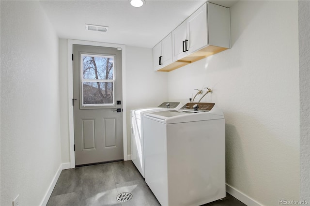 laundry area featuring cabinet space, baseboards, visible vents, and washer and dryer